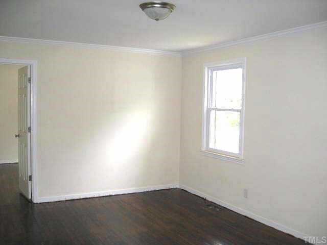2320 Stevens Road Raleigh, NC 27610 - Photo 4 of 10 an empty room with wooden floor and windows