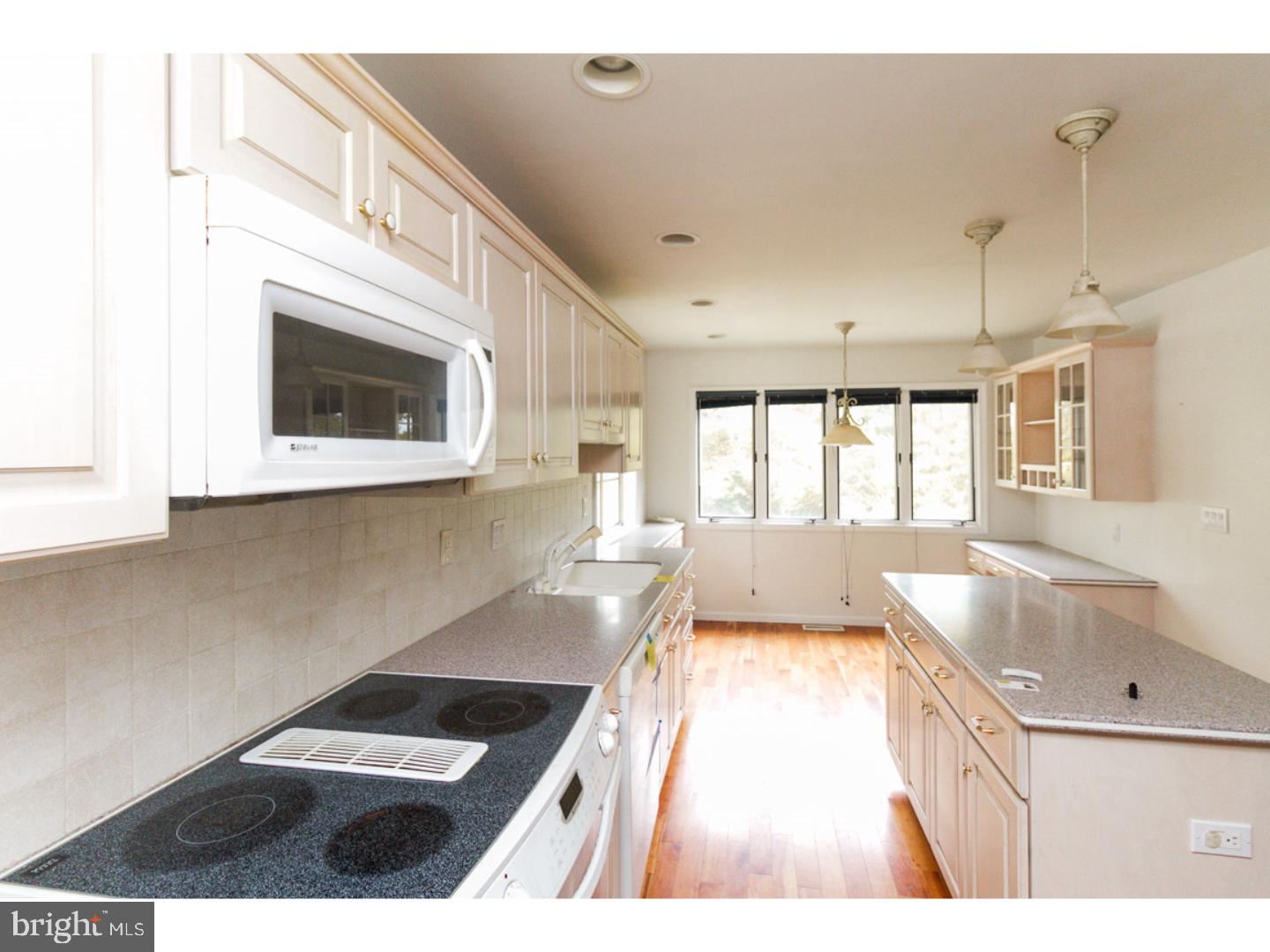 126 Buddtown Road Southampton, NJ 08088 - Photo 2 of 21 a kitchen with stainless steel appliances granite countertop a stove a sink and a microwave