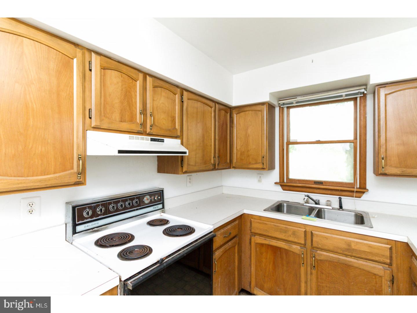 126 Buddtown Road Southampton, NJ 08088 - Photo 18 of 21 a kitchen with a stove a sink and a window