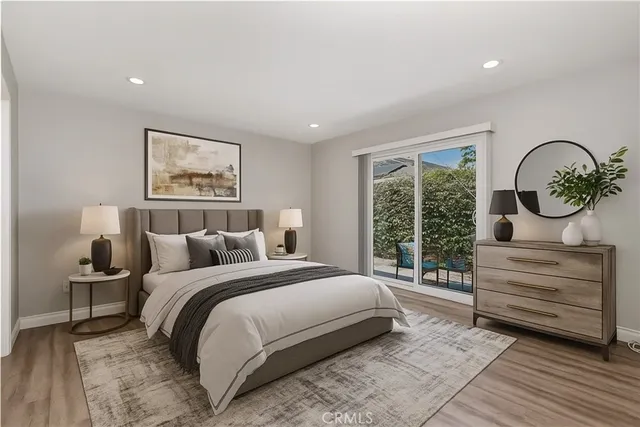 a bedroom with a bed and a large window