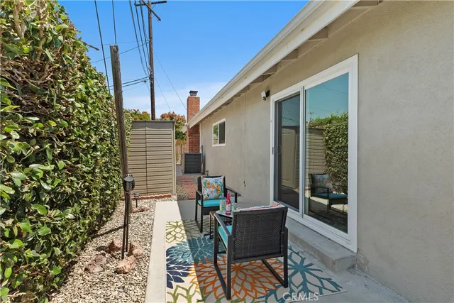 a balcony with wooden floor and outdoor seating