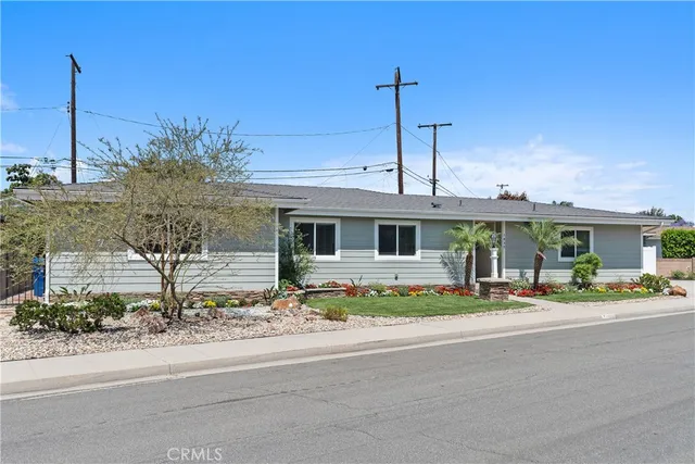 a front view of a house with a garden