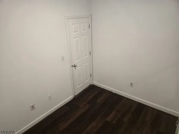 an empty room with wooden floor
