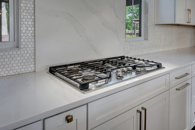 a close up of a stove top oven sitting inside of a kitchen
