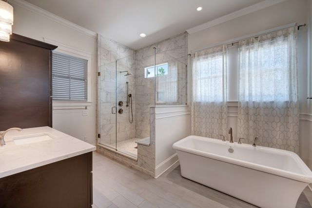 a bathroom with a tub sink and mirror