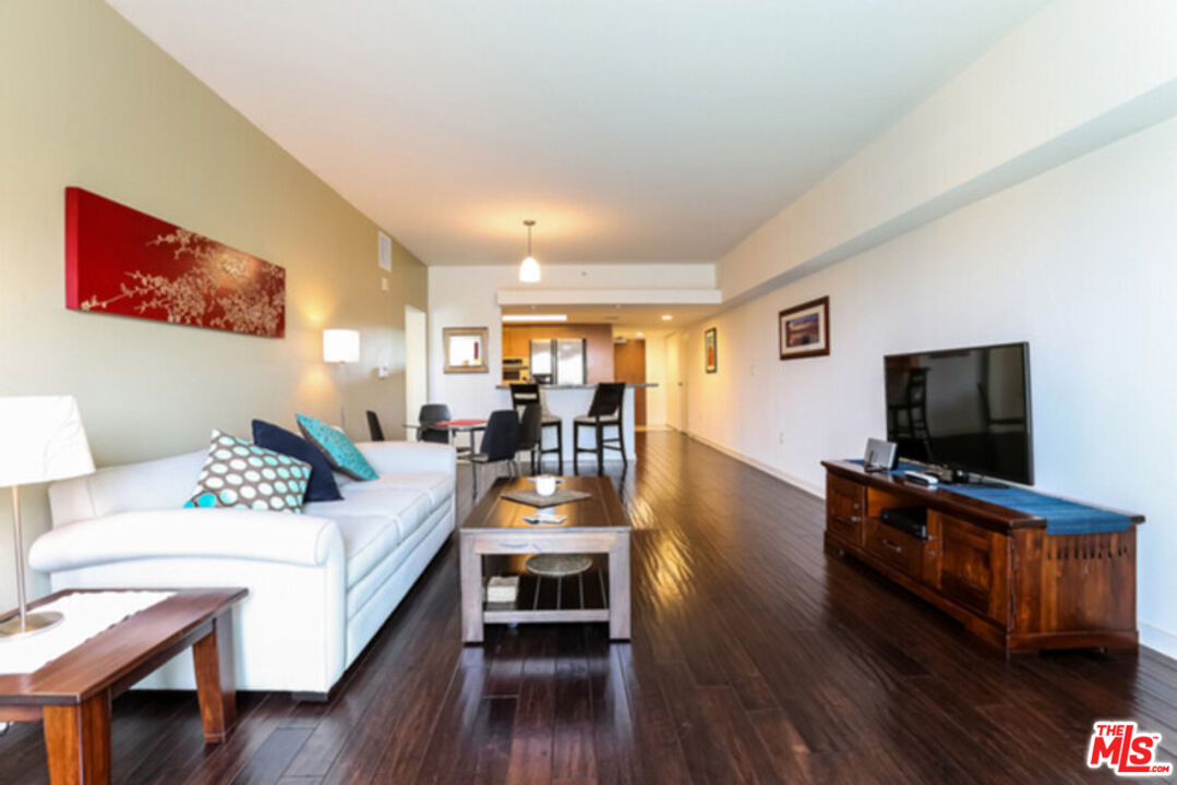 13700 Marina Pointe Drive, Unit 618 Marina del Rey, CA 90292 - Photo 5 of 22 a living room with furniture and a flat screen tv