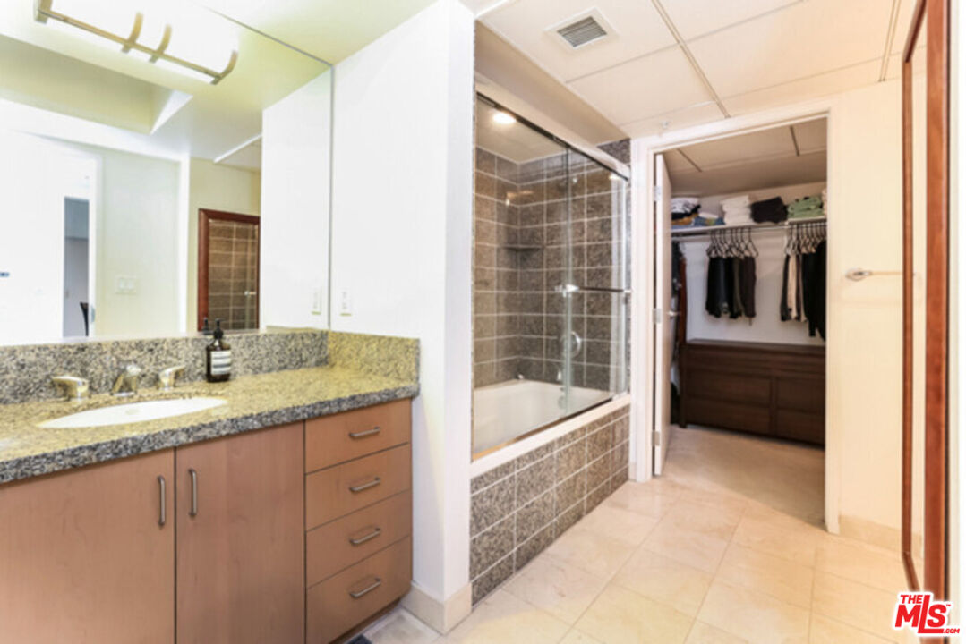 13700 Marina Pointe Drive, Unit 618 Marina del Rey, CA 90292 - Photo 10 of 22 a bathroom with a granite countertop sink and a bathtub