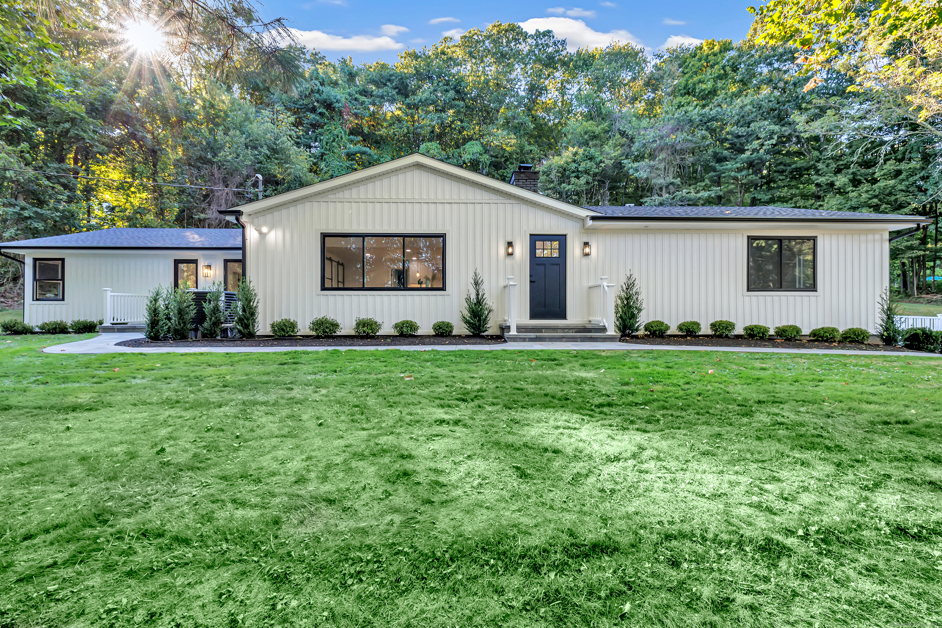 a front view of house with yard and green space