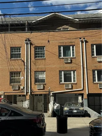 a front view of a building with parking space