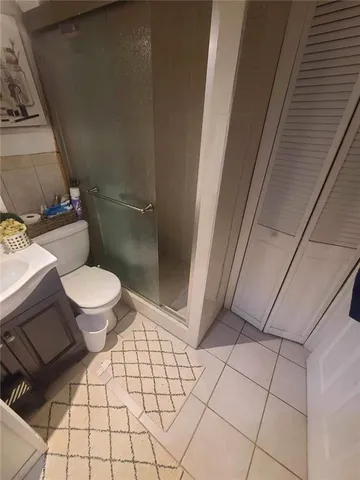 a bathroom with a toilet and a shower