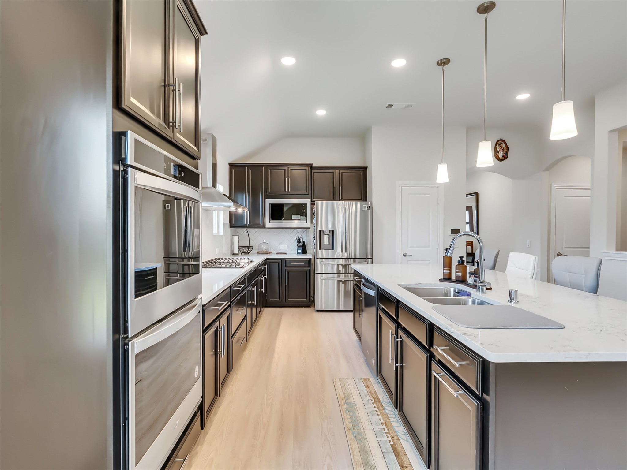 27997 Lone Hollow Lane Spring, TX 77386 - Photo 24 of 45 a kitchen with stainless steel appliances granite countertop a refrigerator a sink dishwasher a oven and a dining table with wooden floor