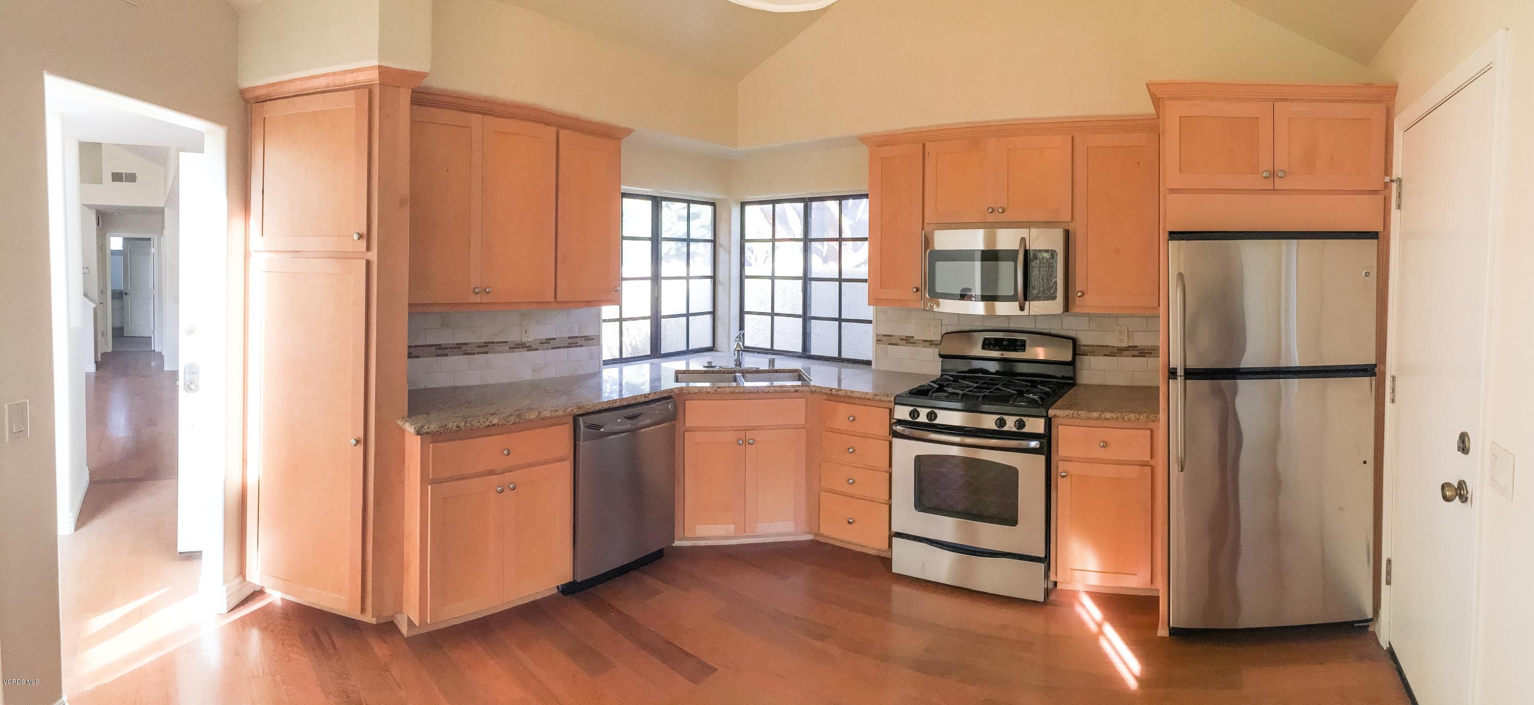 3701 Via Pacifica Walk Oxnard, CA 93035 - Photo 2 of 5 a kitchen with stainless steel appliances granite countertop a refrigerator a stove and a sink
