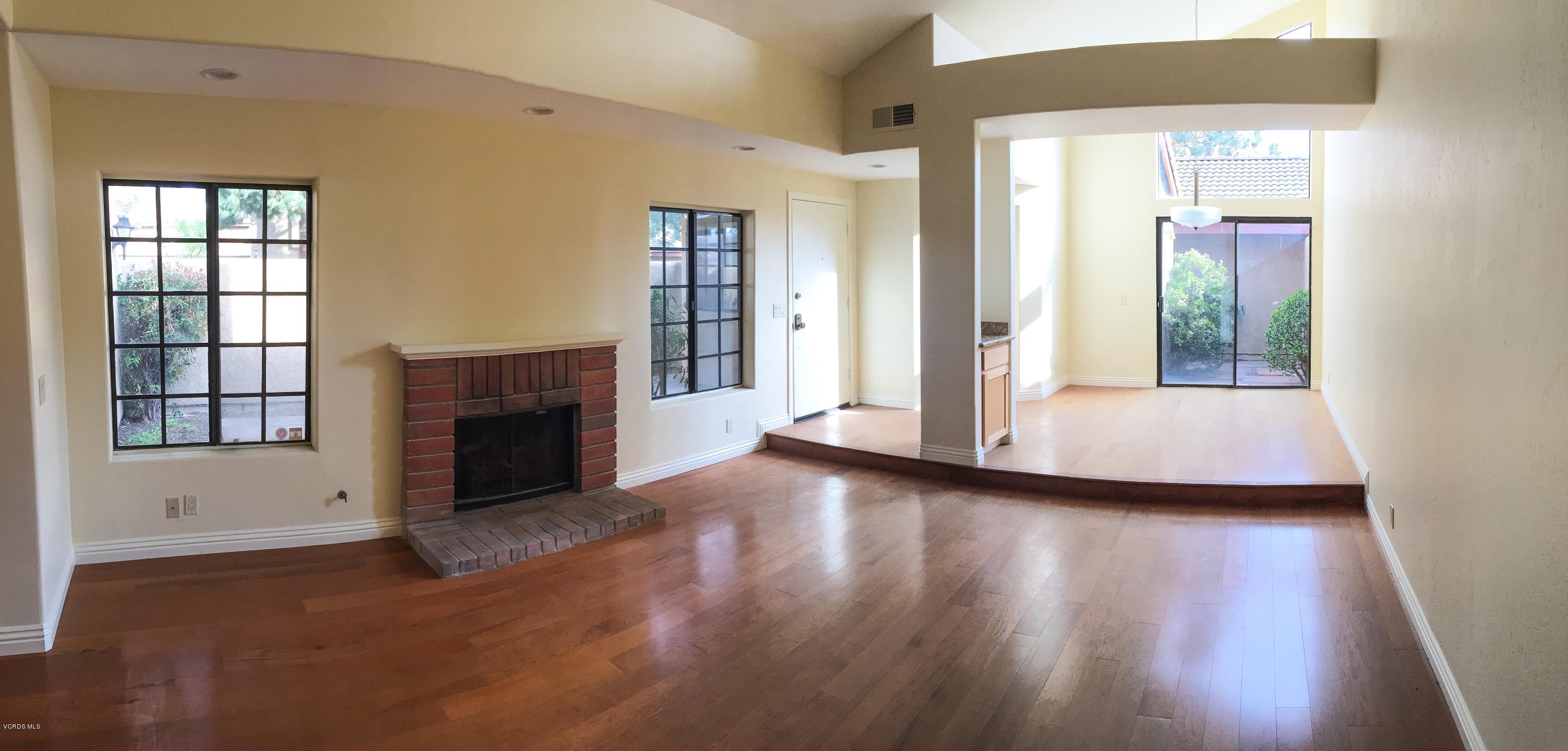 3701 Via Pacifica Walk Oxnard, CA 93035 - Photo 4 of 5 a view of an empty room with wooden floor and a window