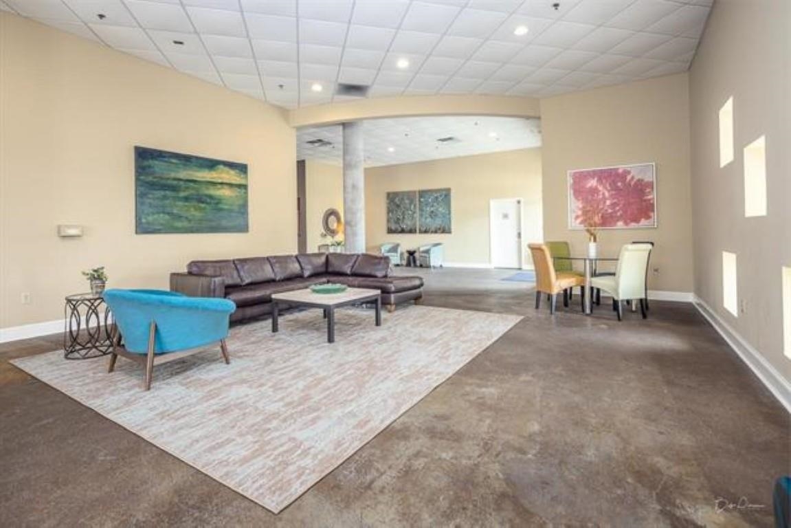 648 Riverside Drive, Unit 319 Memphis, TN 38103 - Photo 13 of 19 a living room with furniture and a chandelier