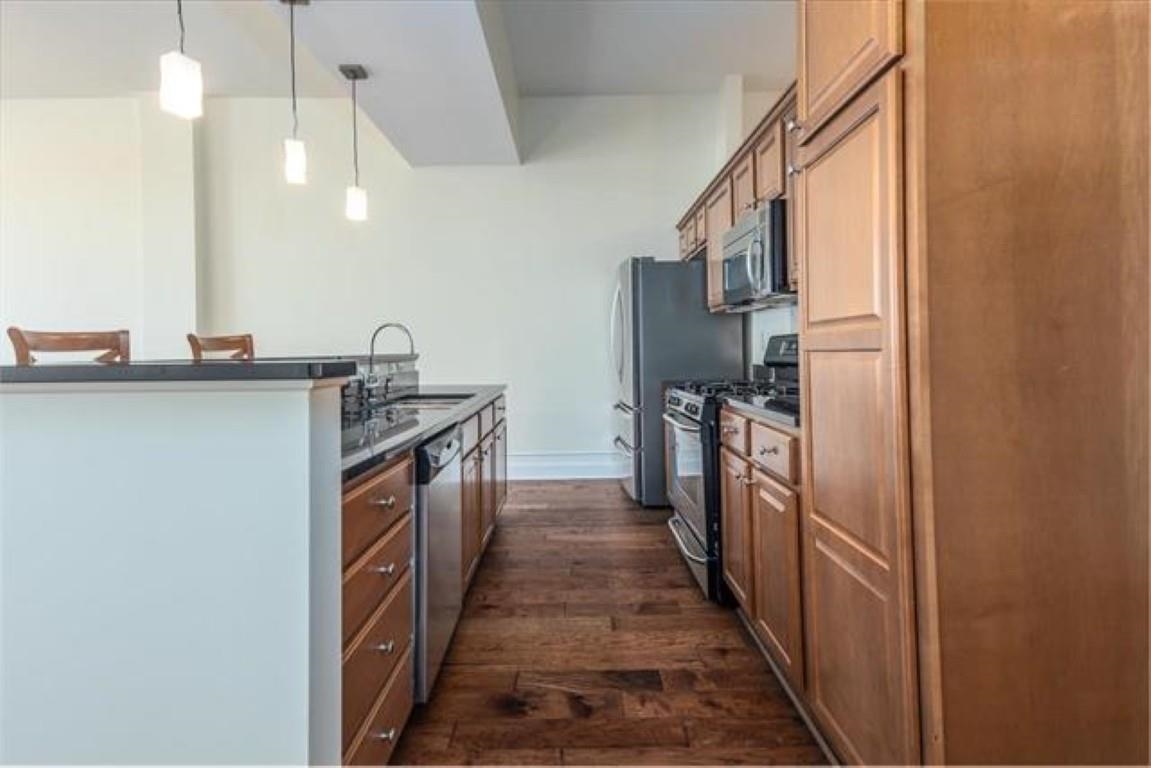 648 Riverside Drive, Unit 319 Memphis, TN 38103 - Photo 6 of 19 a kitchen with stainless steel appliances granite countertop a sink and a refrigerator