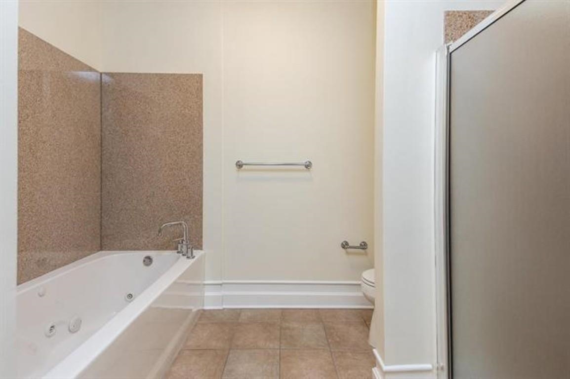 648 Riverside Drive, Unit 319 Memphis, TN 38103 - Photo 10 of 19 a bathroom with a bathtub and a shower