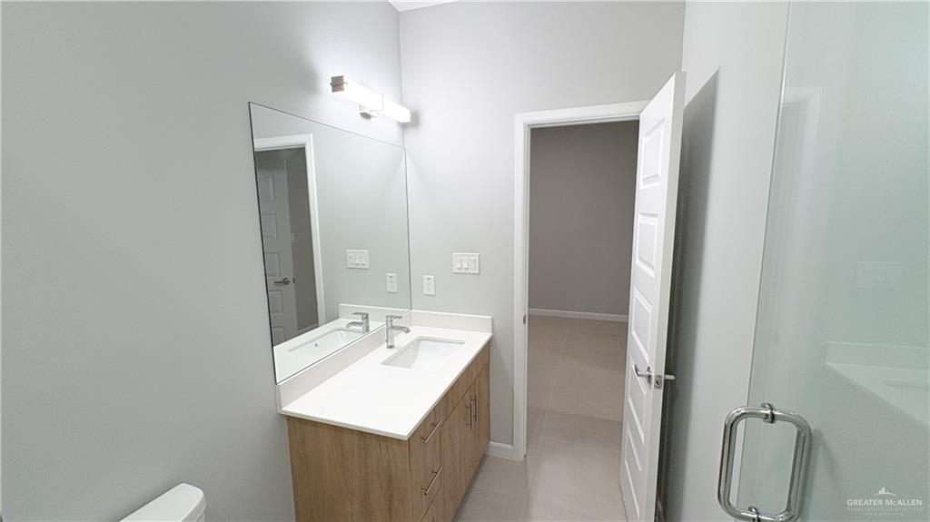 612 Oriole Road Weslaco, TX 78596 - Photo 12 of 16 a bathroom with a sink a toilet and shower