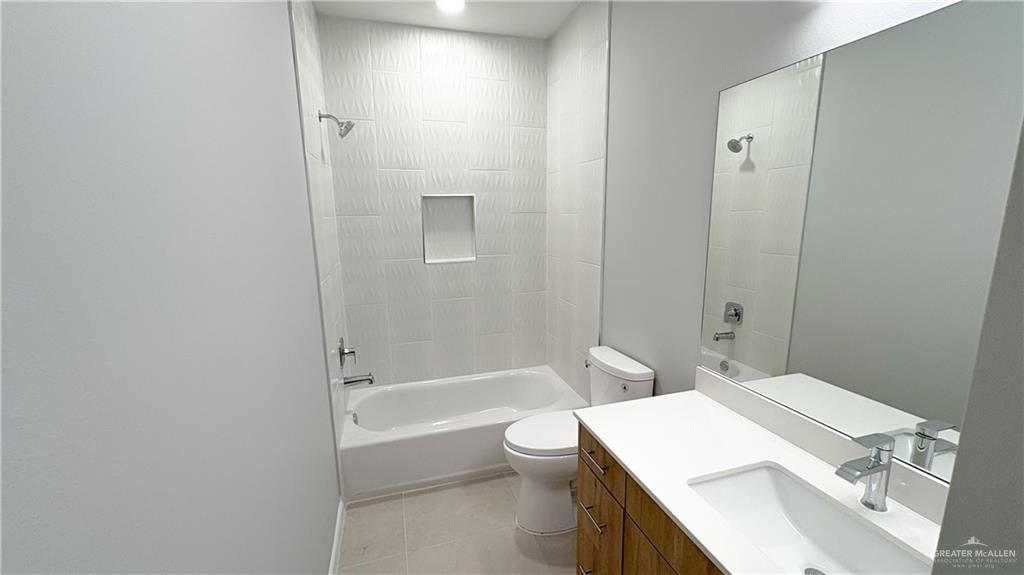 612 Oriole Road Weslaco, TX 78596 - Photo 15 of 16 a bathroom with a sink a toilet and shower