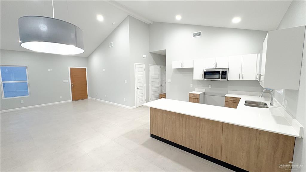 612 Oriole Road Weslaco, TX 78596 - Photo 2 of 16 a large white kitchen with a large counter top appliances and cabinets