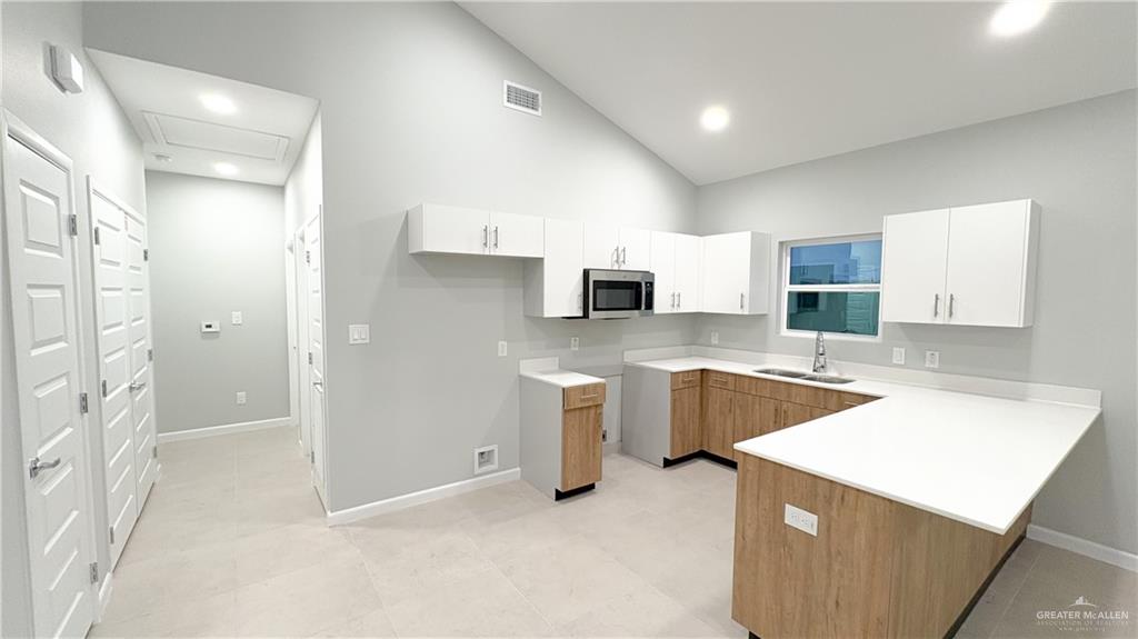 612 Oriole Road Weslaco, TX 78596 - Photo 5 of 16 a kitchen with a sink cabinets and wooden floor