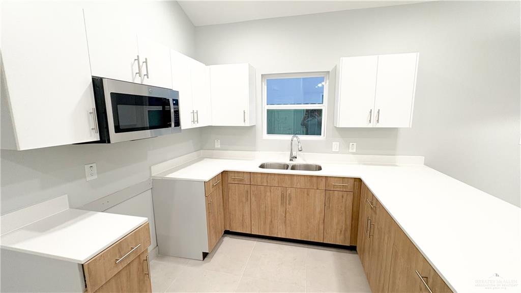 612 Oriole Road Weslaco, TX 78596 - Photo 6 of 16 a kitchen with stainless steel appliances a sink stove and cabinets