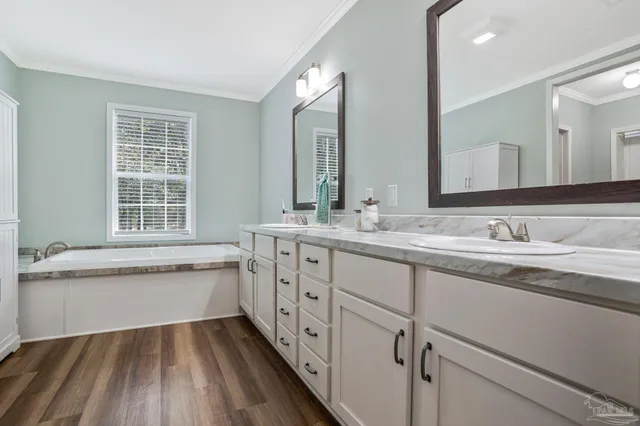 a bathroom with a granite countertop sink and a large mirror