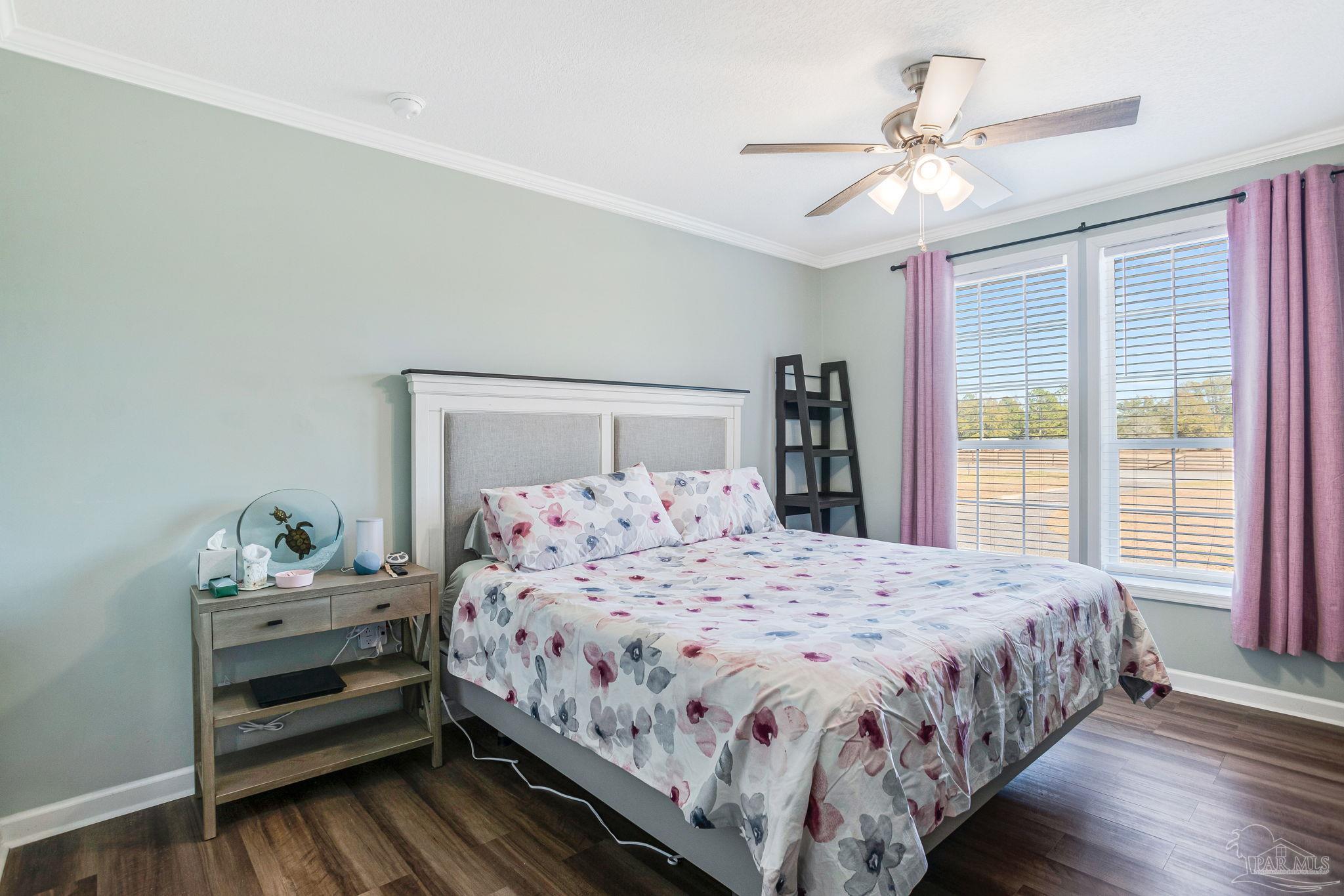4955 Blue Ribbon Drive Milton, FL 32583 - Photo 22 of 43 a bedroom with a bed and a window