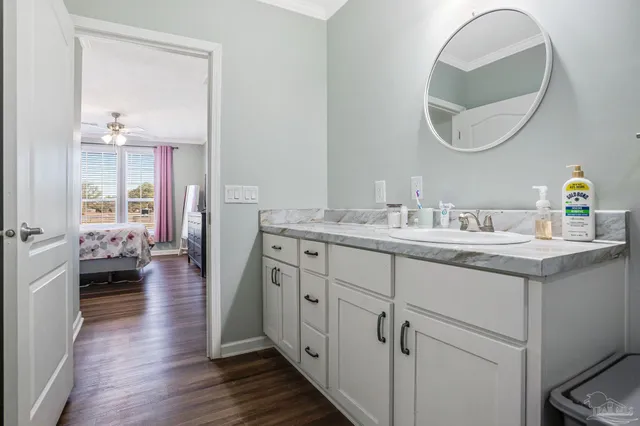 a bathroom with a granite countertop toilet sink and mirror