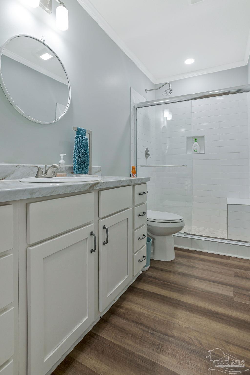 4955 Blue Ribbon Drive Milton, FL 32583 - Photo 26 of 43 a bathroom with a sink toilet a mirror and shower