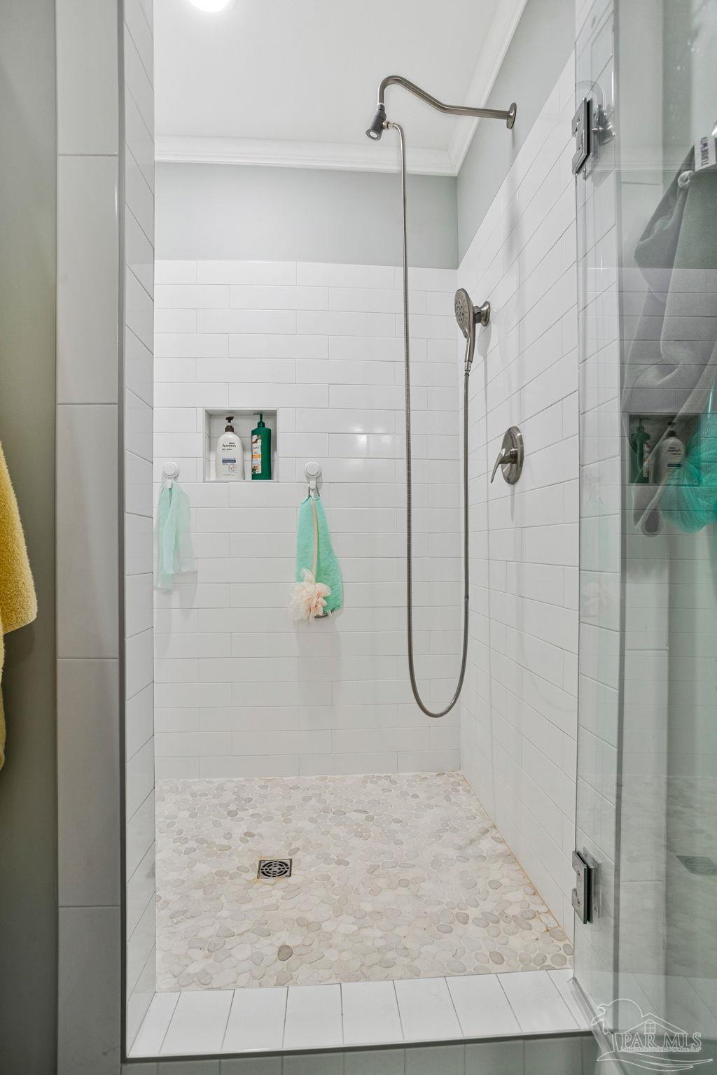 4955 Blue Ribbon Drive Milton, FL 32583 - Photo 27 of 43 a bathroom with a glass shower door