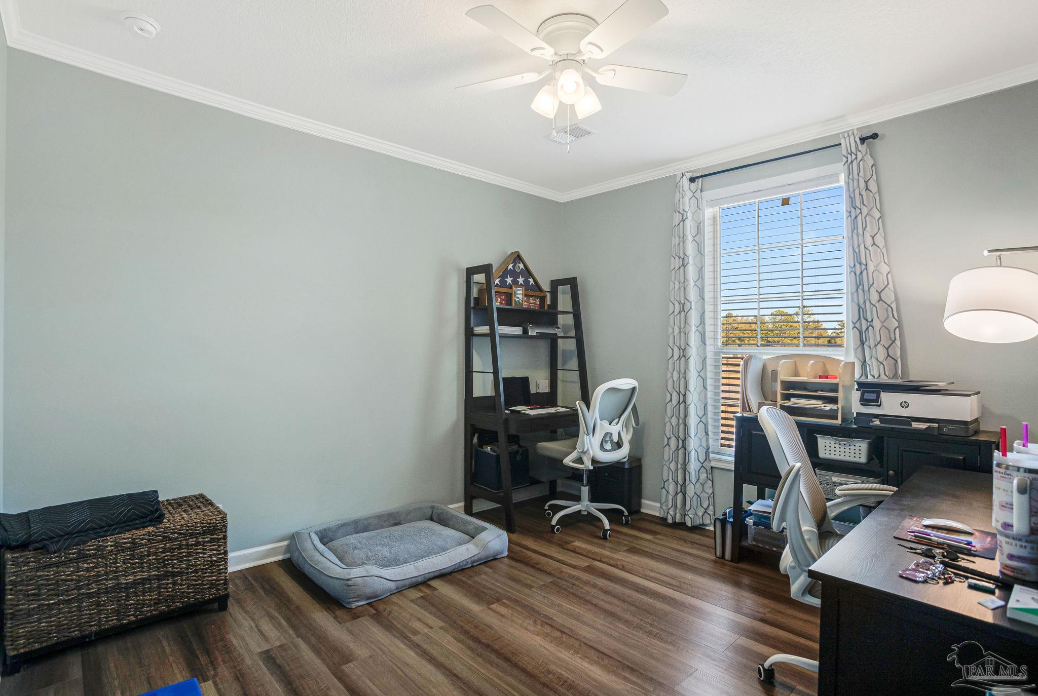 4955 Blue Ribbon Drive Milton, FL 32583 - Photo 28 of 43 a view of workspace with wooden floor windows gym equipment and windows