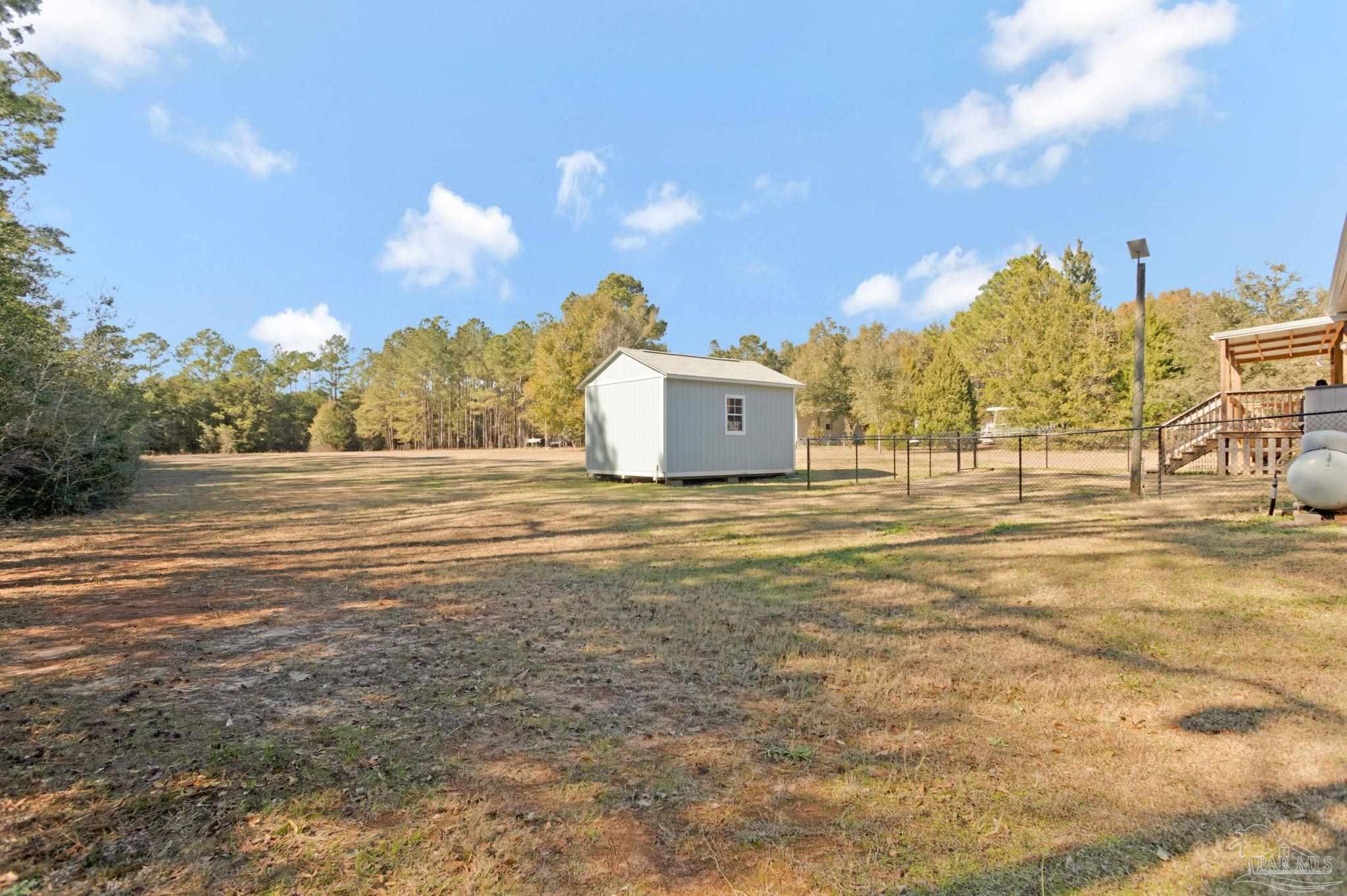4955 Blue Ribbon Drive Milton, FL 32583 - Photo 38 of 43 a view of a large body of water with a building in the background