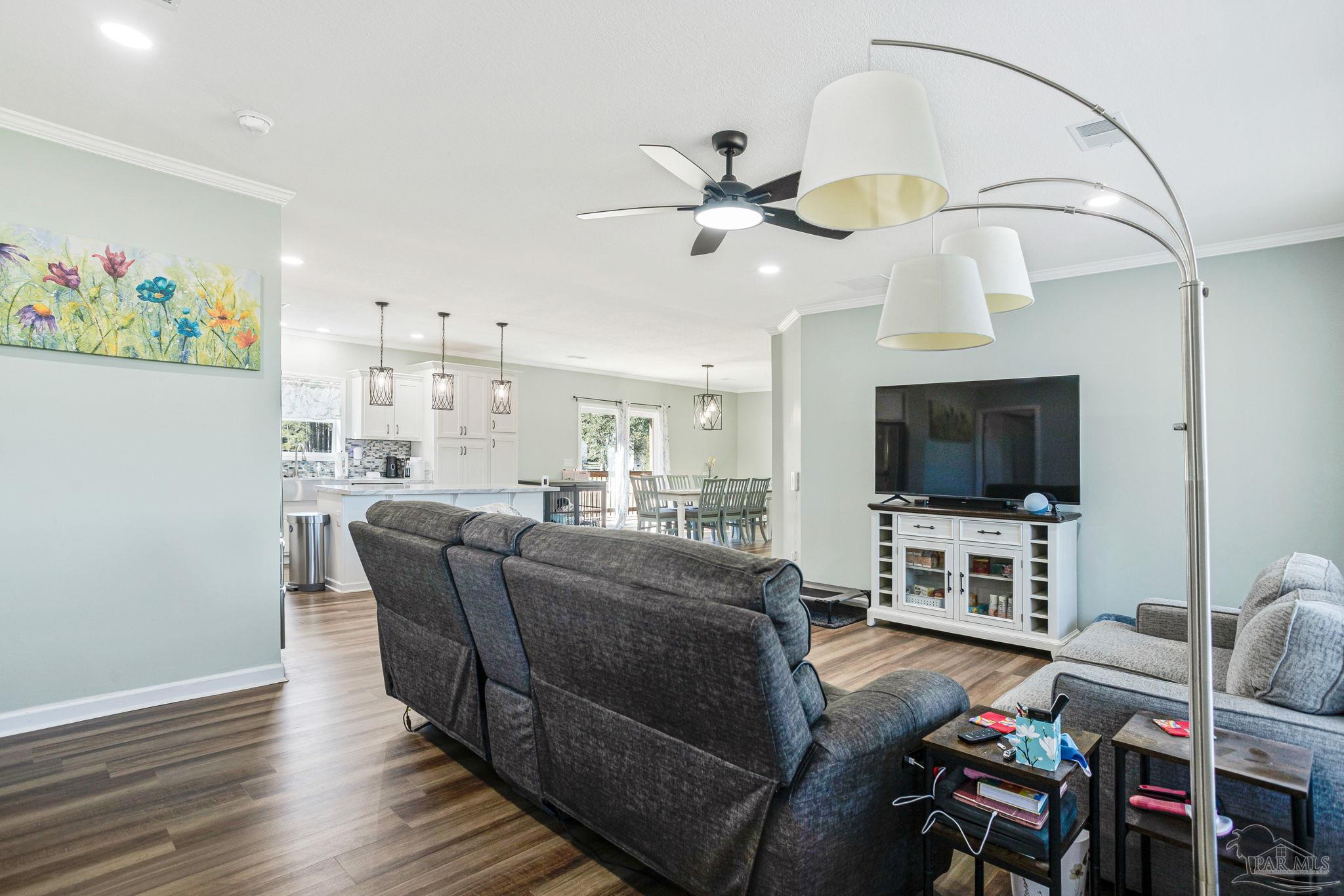 4955 Blue Ribbon Drive Milton, FL 32583 - Photo 5 of 43 a living room with furniture and a flat screen tv
