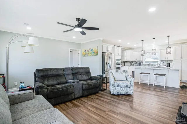 a living room with furniture and kitchen view