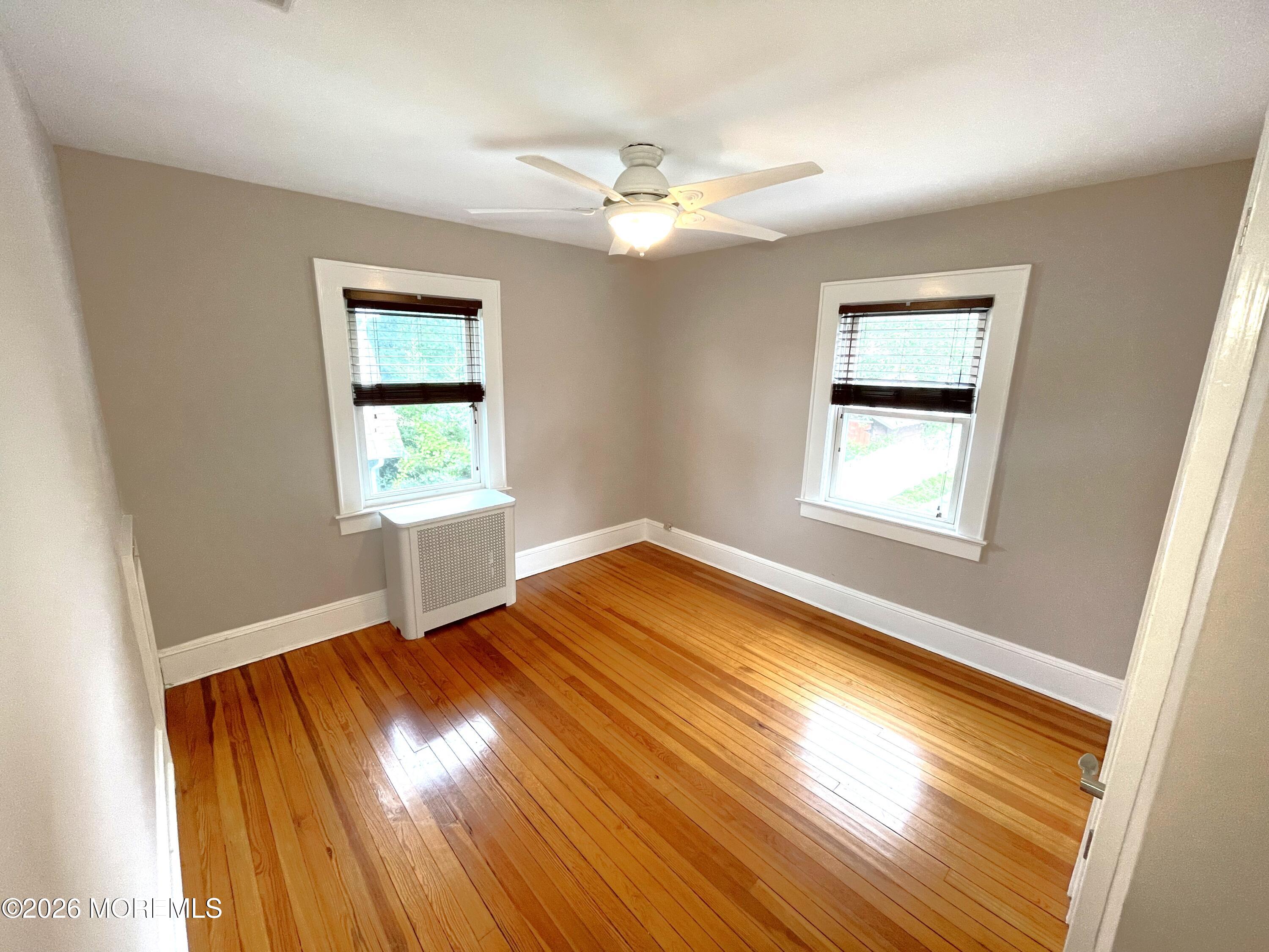 175 Highway 35 Red Bank, NJ 07701 - Photo 12 of 15 a view of an empty room with wooden floor and a window