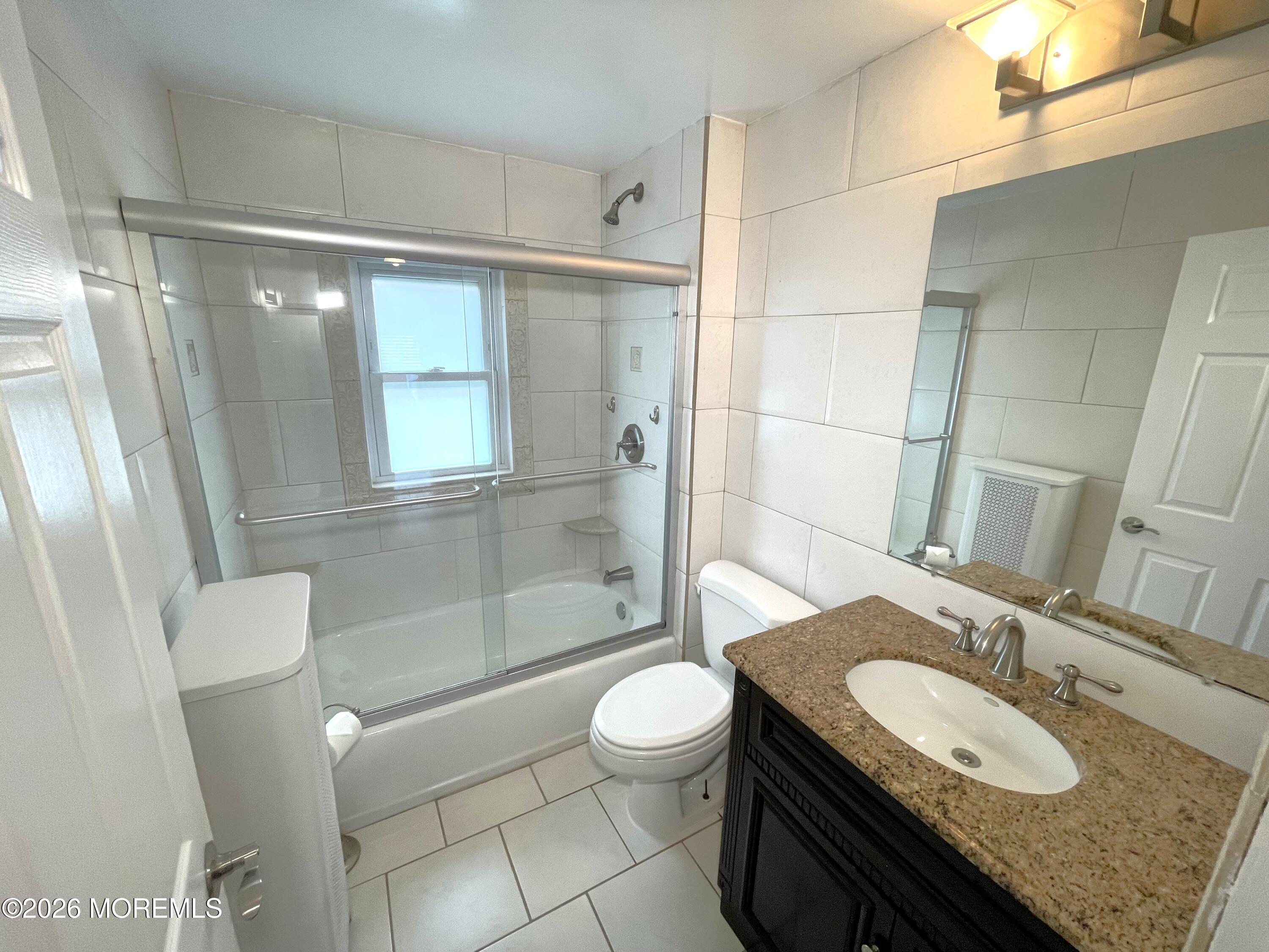 175 Highway 35 Red Bank, NJ 07701 - Photo 15 of 15 a bathroom with a granite countertop sink toilet a mirror and shower