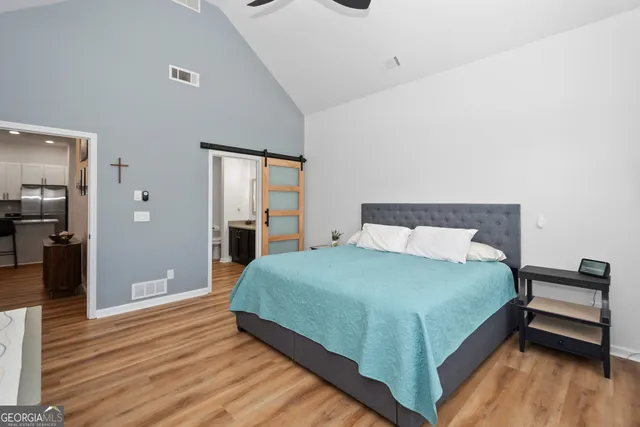 a large bed sitting in a bedroom and a table