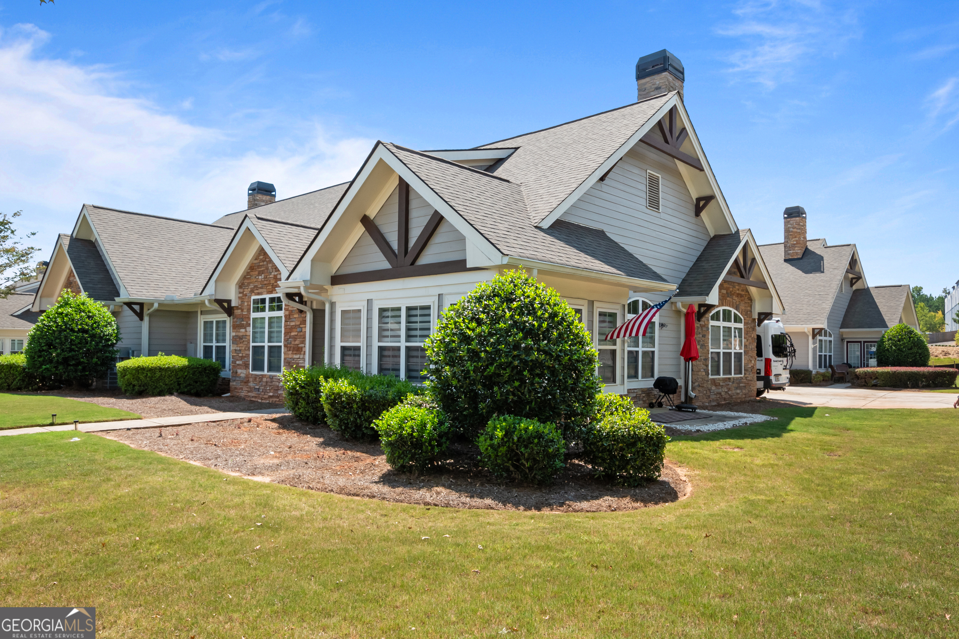 71 Thomaston Street Newnan, GA 30263 - Photo 2 of 38 a front view of a house with a yard table and chairs