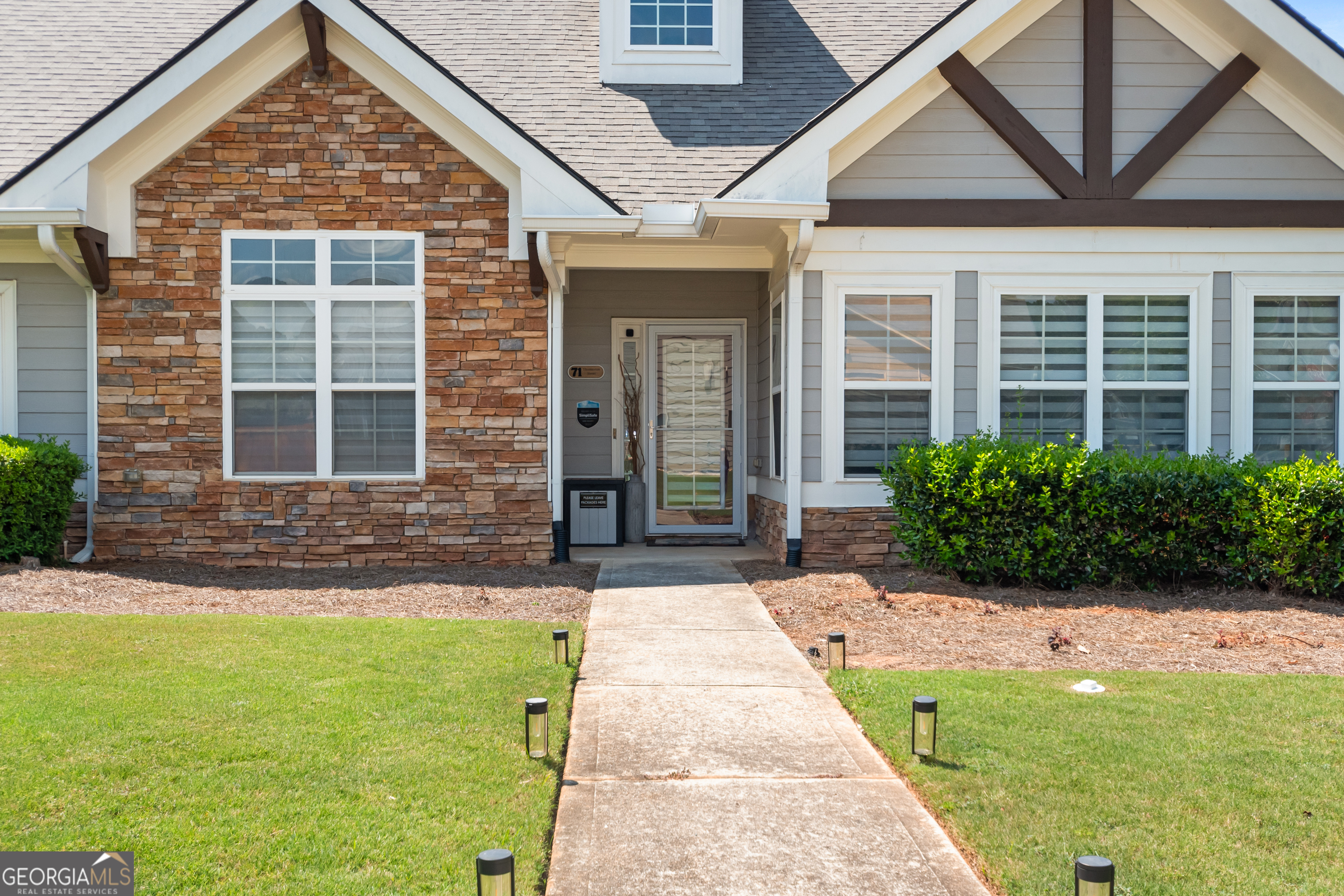 71 Thomaston Street Newnan, GA 30263 - Photo 34 of 38 a front view of a house with garden