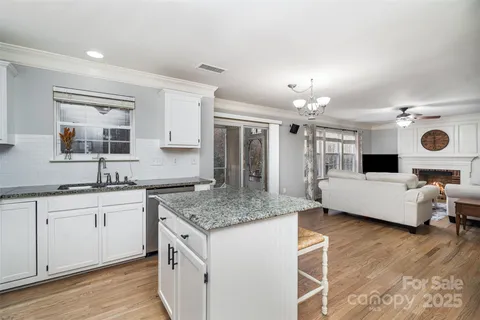 a spacious bathroom with a granite countertop sink and a mirror