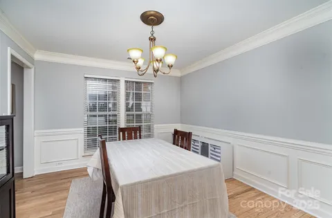a view of a dining room with a table and chairs