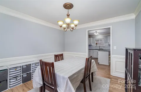 a view of a dining room with furniture and chandelier