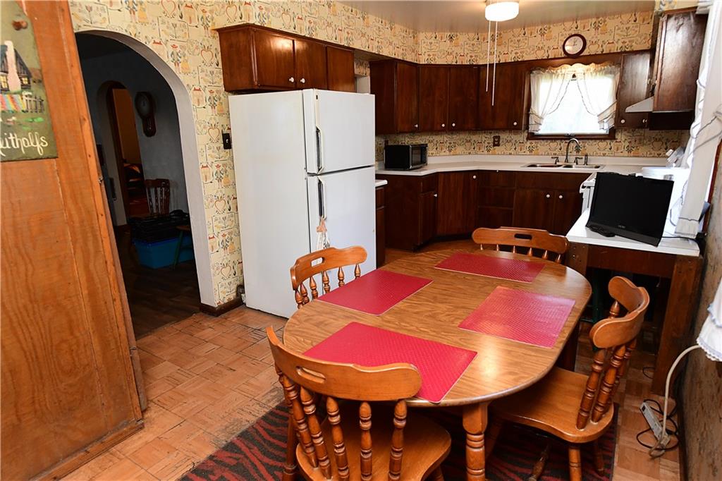 145 Moose Road Renfrew, PA 16053 - Photo 13 of 23 a kitchen with a refrigerator a table and chairs