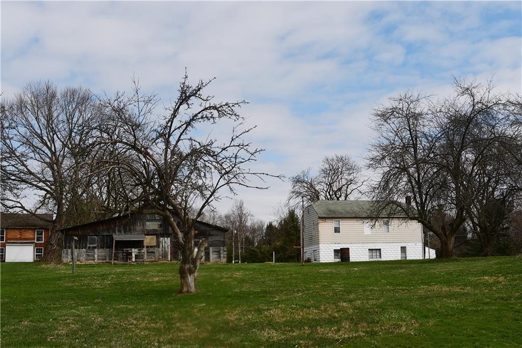 145 Moose Road Renfrew, PA 16053 - Photo 8 of 23 a big white house with a big yard and large trees