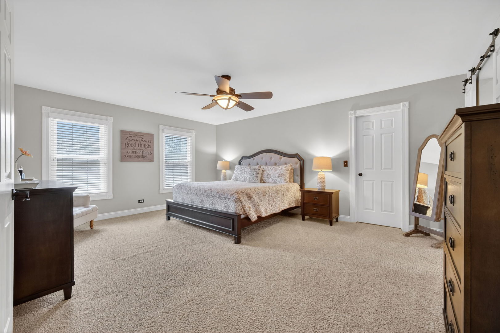 5304 Rita Avenue Crystal Lake, IL 60014 - Photo 29 of 59 a spacious bedroom with a bed and a chandelier