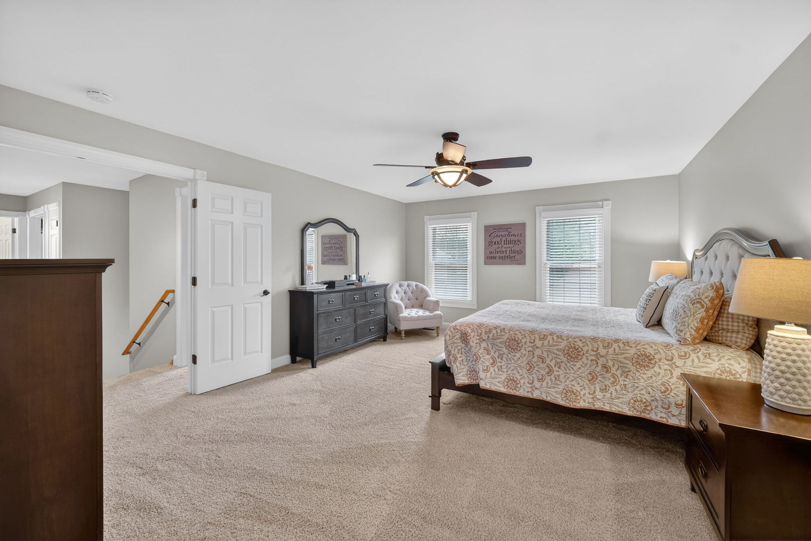 5304 Rita Avenue Crystal Lake, IL 60014 - Photo 30 of 59 a spacious bedroom with a bed a couch and a chandelier