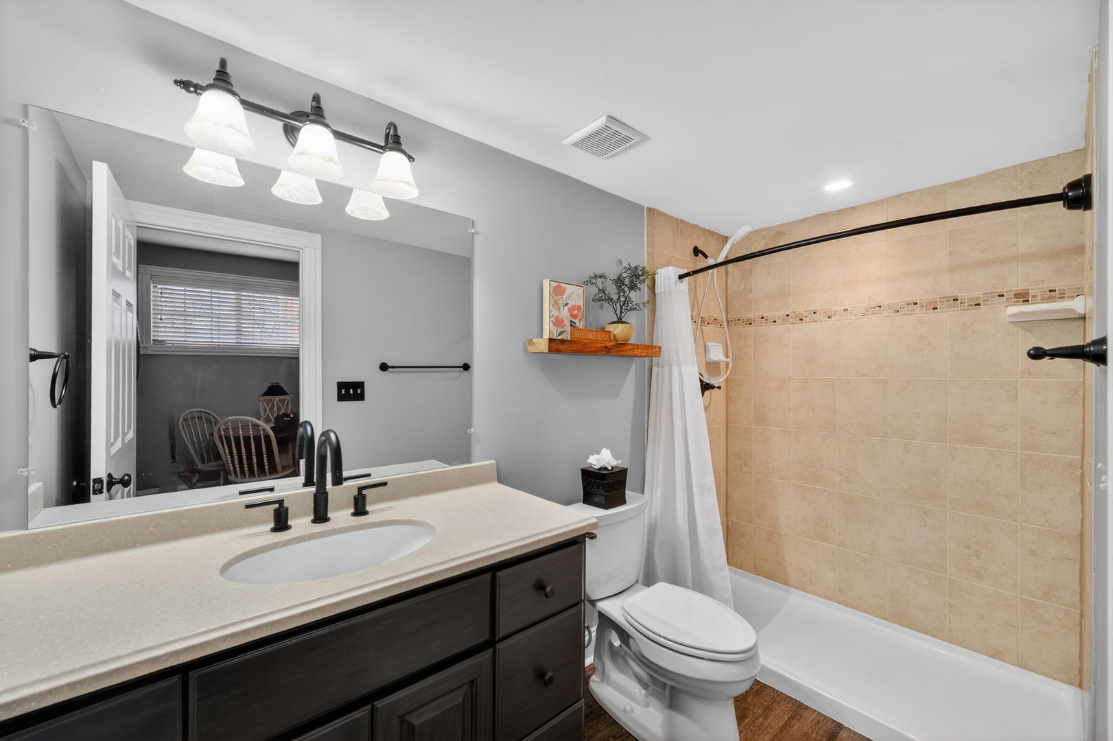 5304 Rita Avenue Crystal Lake, IL 60014 - Photo 44 of 59 a bathroom with a sink a toilet a mirror a vanity and shower