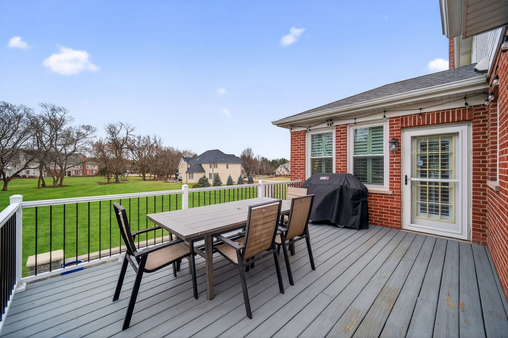 5304 Rita Avenue Crystal Lake, IL 60014 - Photo 47 of 59 a view of a deck with table and chairs and wooden floor