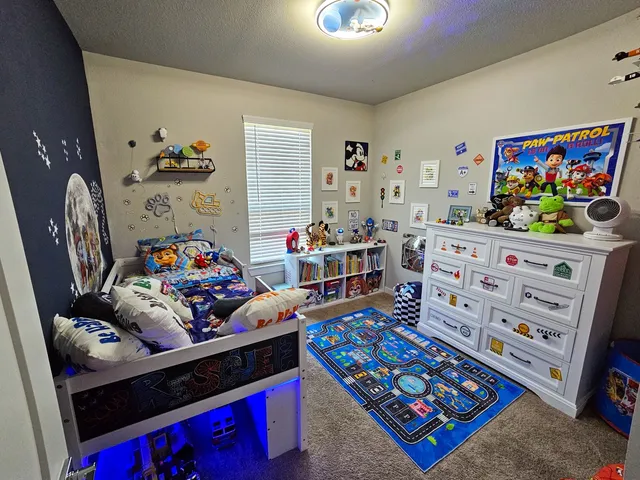a bedroom with furniture and a wooden floor
