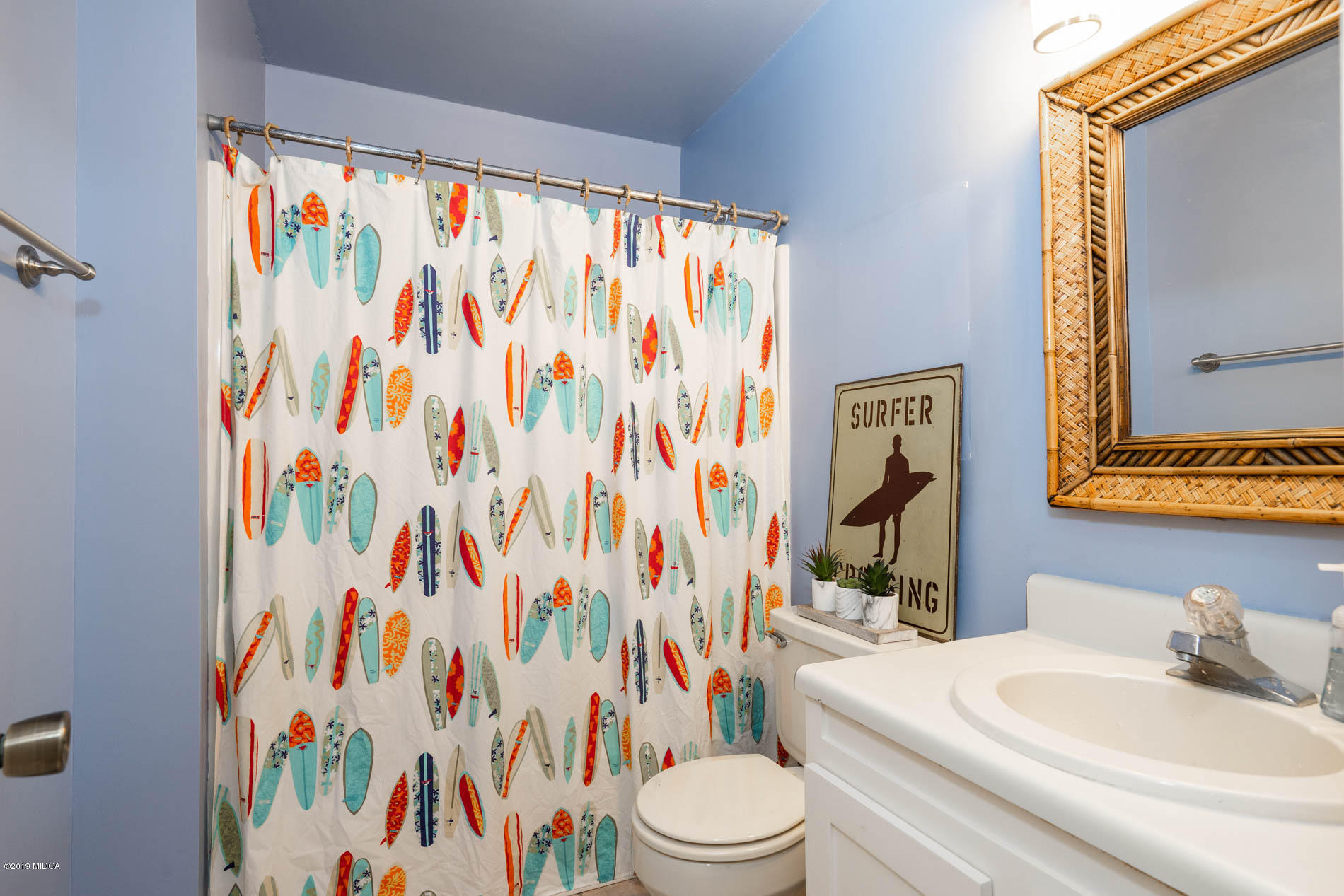 123 Timber Ridge Drive Macon, GA 31216 - Photo 14 of 26 a bathroom with a sink a toilet and shower curtain